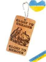 This unique Ukrainian  wooden keychain is an expression of true artistry and national pride. Crafted from natural wood, it features an exquisite illustration embodying the glory and bravery of the Ukrainian people. Depicting a historical Ukrainian warrior with modern weaponry, the keychain symbolizes the aspiration for victory in the ongoing war on our homeland, Ukraine. On the back side of our Ukrainian wooden keychain you will find an image of a brave wolf, or a coat of arms, or an M142. Please indicate which image you would like when ordering.